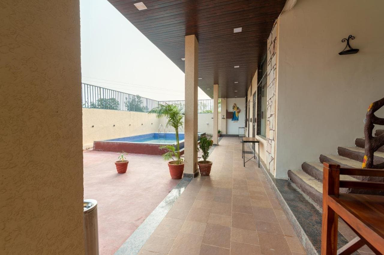 Covered stone verandah leading to the swimming pool