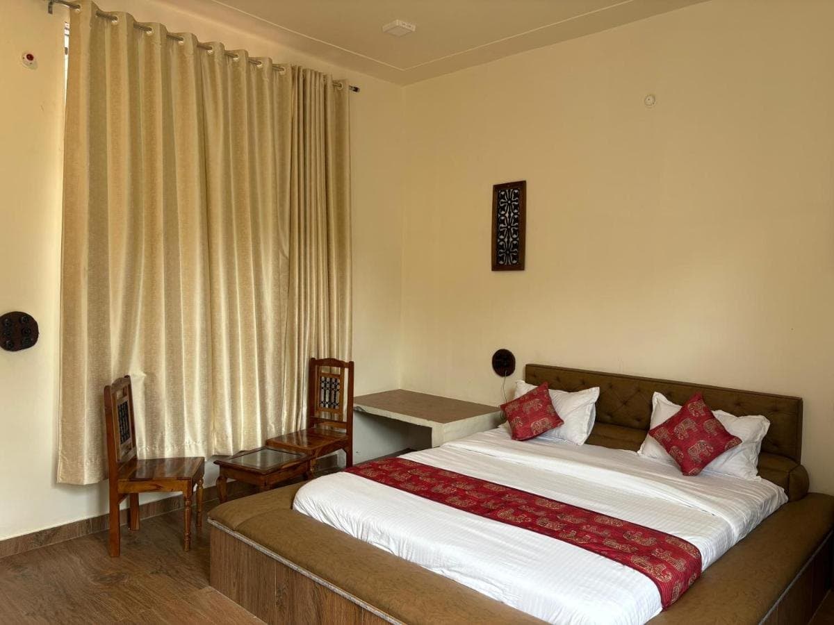 Bright double room with curtains and a work desk