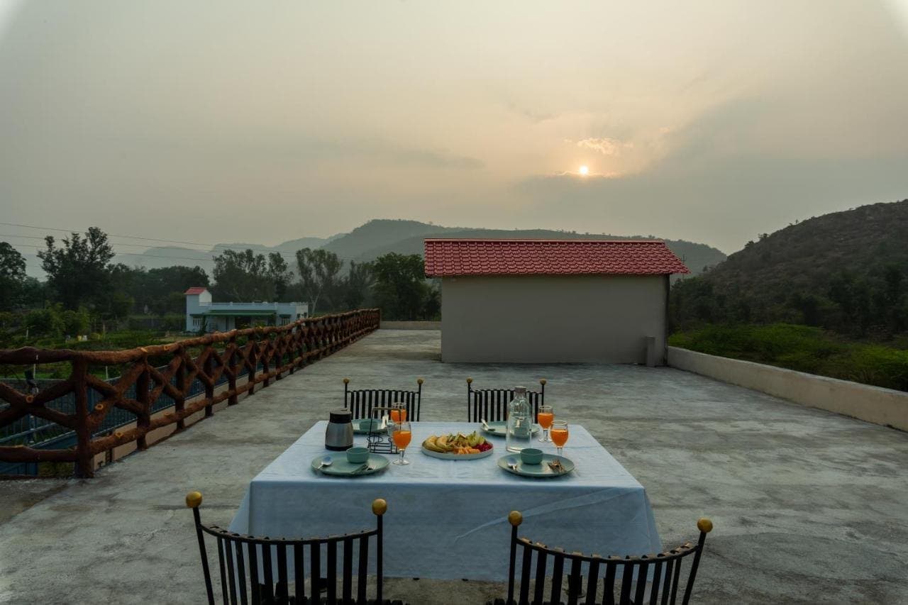 Rooftop table at sunset with the hills on the horizon